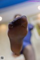 A close up of a woman's feet in black pantyhose.