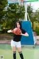 A woman holding a basketball on a basketball court.