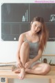 A woman sitting on top of a wooden table.