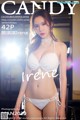 A woman in a white bikini posing for a magazine cover.